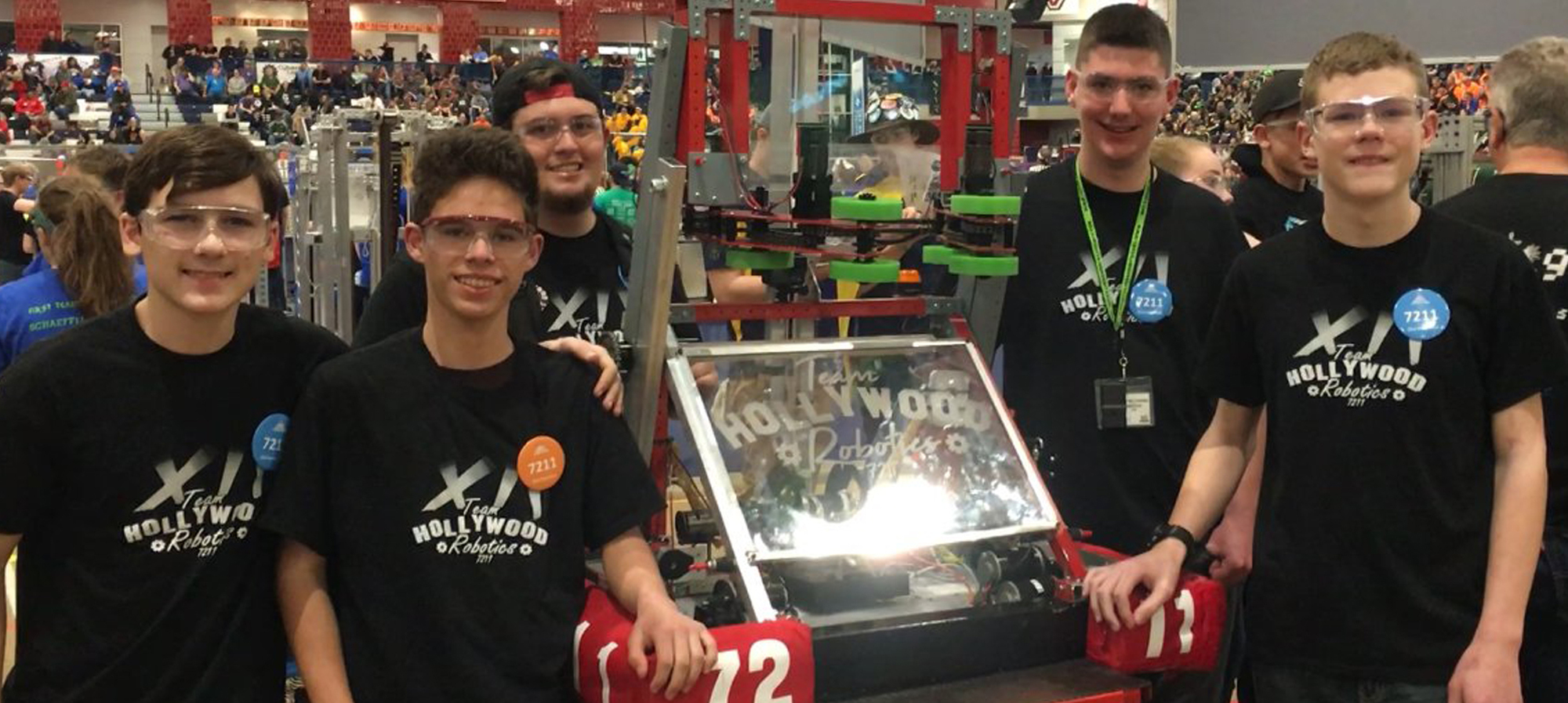 Students from the Hollywood Robotics Team 7211 with their robot