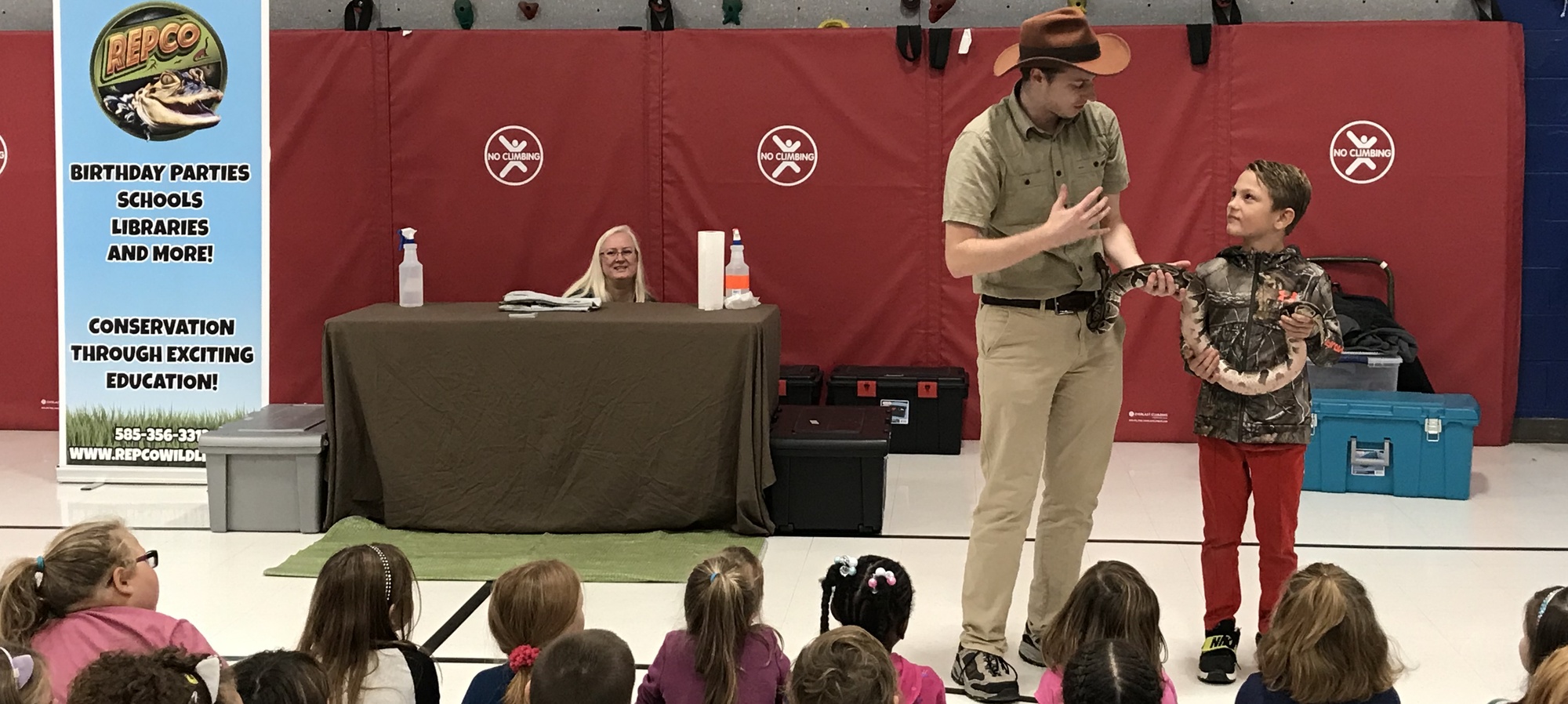 Repco representative with one of our students holding and learning about a snake