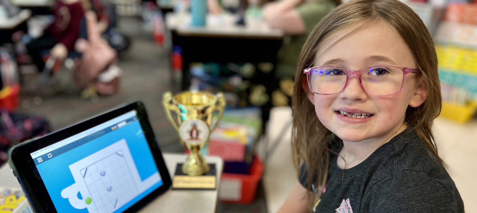 Student in Mrs. Brown's class with her STMath award