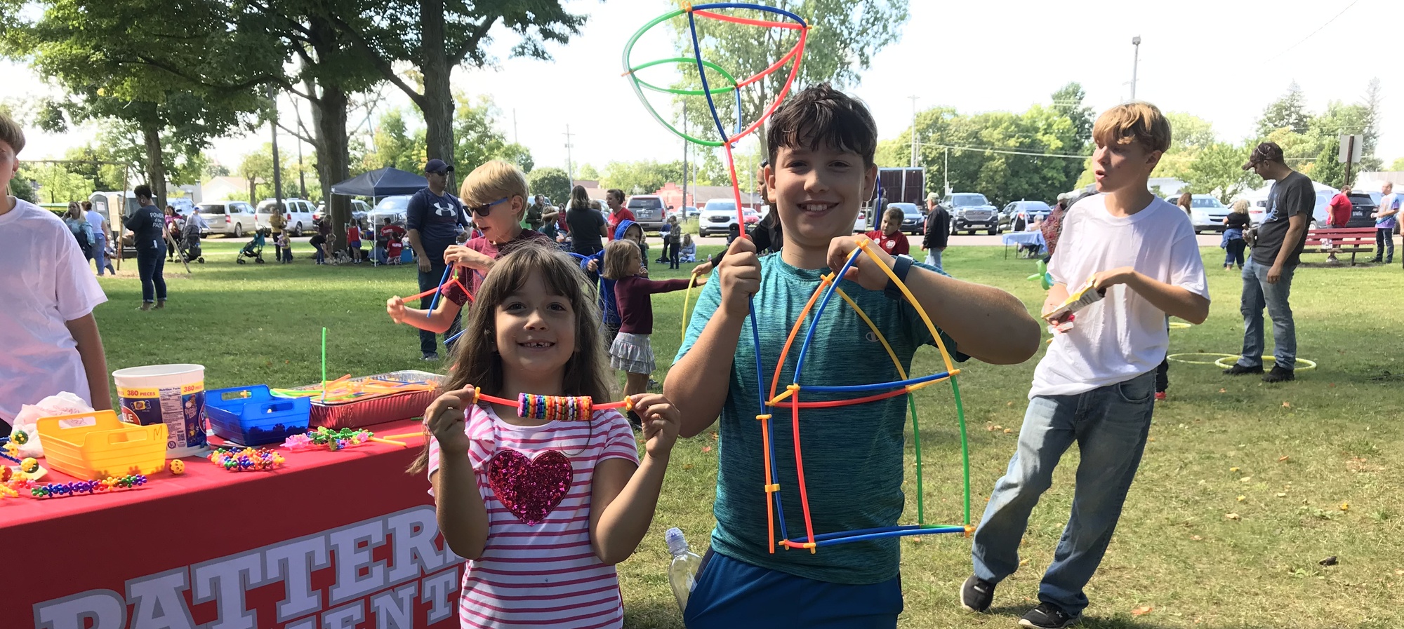 Patterson Play Day pictures with a boy and girl holding the items they made