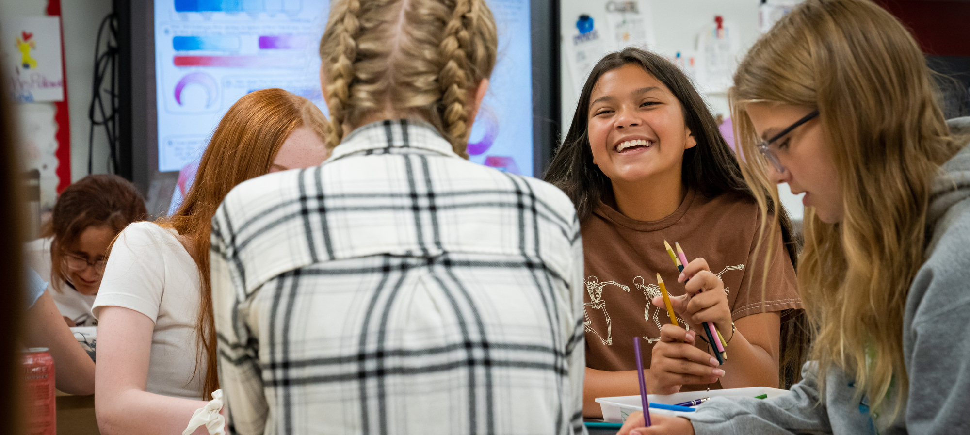 Students in class.  One student is smiling