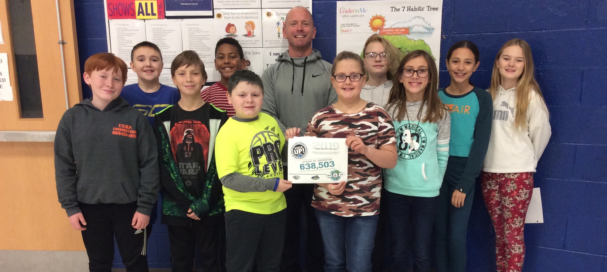 Students with Mr. McLaughlin and their certificate breaking the record for cup stacking