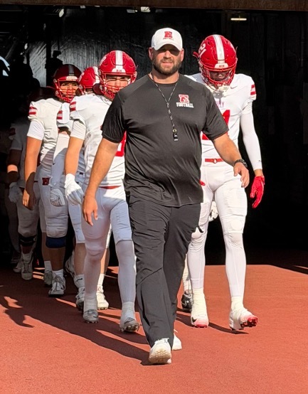 Coach Keenist and players walking out of the tunnel