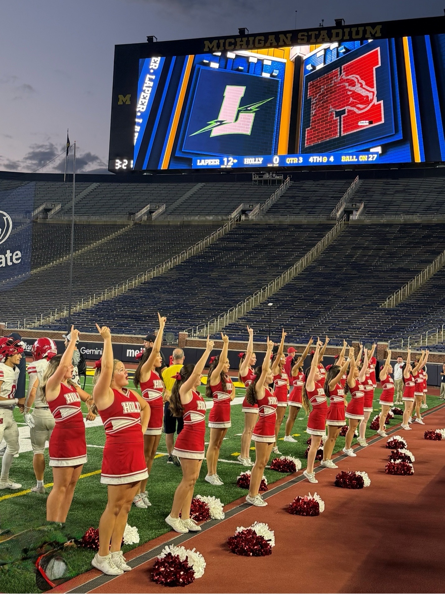 Holly high school varsity cheer team performing at the Big House